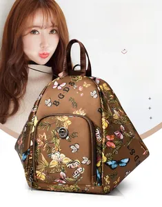 Close-up of butterfly print nylon backpack featuring a kangaroo logo and multiple compartments