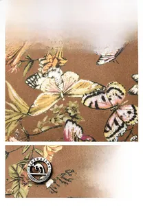 Detail of cowhide fabric with butterfly floral print and gold kangaroo brand hardware