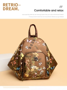 Detailed close-up of brown floral backpack showing silk texture and metal kangaroo emblem