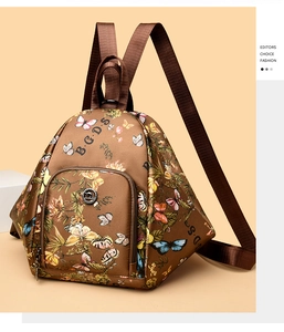 Detail of colorful butterfly floral prints and brand logo on brown fashion backpack