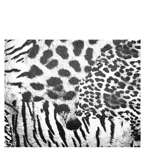 Close-up of black and white leopard and tiger print stitching on durable leather bag