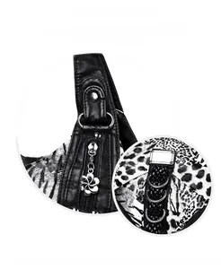 Detail of leopard print canvas and silver petal zipper pull on washed leather bag