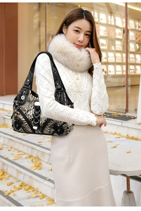 Detail of leopard print shoulder bag with metal floral charm and silver ring accents