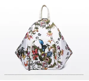 Close-up of white waterproof backpack with floral butterfly patterns and diamond texture