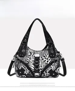 Detail view of large animal print tote bag featuring metallic rings and petal charms