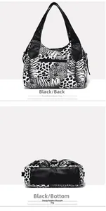 Detail view of animal print shoulder bag showing back zipper and flat leather base