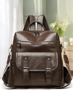 Close-up of brown vintage soft leather backpack with twin buckles and textured finish