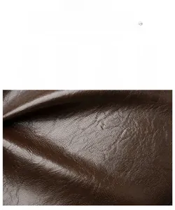 Detail of dark brown leather texture with lychee pattern and water-resistant finish
