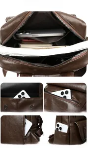 Detail view of multi-pocket brown leather backpack with lychee texture and anti-theft design