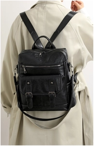 Detailed back view of a black retro PU leather backpack featuring multiple zip pockets