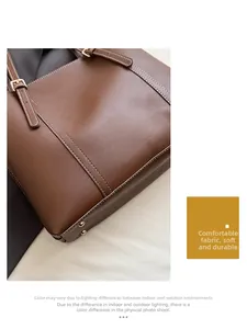 Detail of brown tote bag with white decorative stitching and gold metal studs