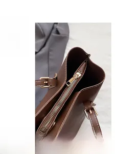 Detail of smooth metal zipper and spacious interior of the vintage brown leather tote bag