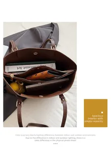 Internal view of the brown leather tote bag showing large capacity and zipper compartments