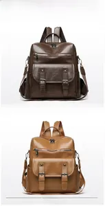 Detail of dark brown and yellow brown vintage leather backpacks with metal buckles