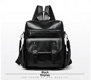 Front detail of black faux leather backpack showing magnetic flap and metal buckles