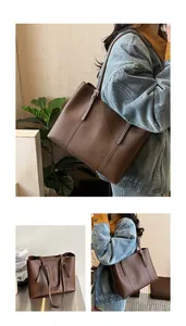 Detail of vintage brown leather tote bag with fine stitching and slim shoulder straps