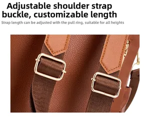 Detail of adjustable litchi leather and nylon shoulder strap with gold metal buckle