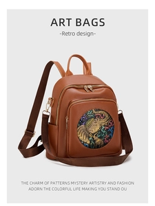 Close-up of vintage brown pebble leather backpack with a colorful elephant embossed design