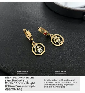 Detail of gold titanium steel Hand of Fatima earrings showing 0.95cm size and 3.5g weight