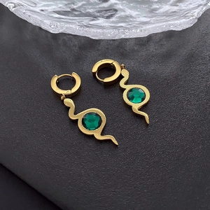 Golden snake hoop earrings with hammered texture and green zircon stone on black background