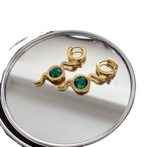 Golden snake hoop earrings with green zircon pendant and textured metal finish