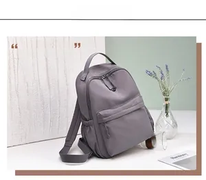 Detail view of purple waterproof nylon backpack featuring spacious main compartment and side pockets