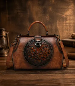 Detailed view of the vintage embossed flower pattern on dark brown leather handbag