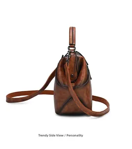 Side view of vintage brown embossed leather handbag with metal hardware and shoulder strap