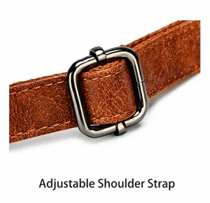 Close-up of adjustable brown leather shoulder strap with a gunmetal rectangular buckle
