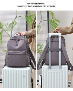 Detail view of purple nylon backpack with luggage strap and water-resistant fabric