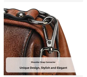 Detailed close-up of brown vintage leather bag showing metal hook and strap connection