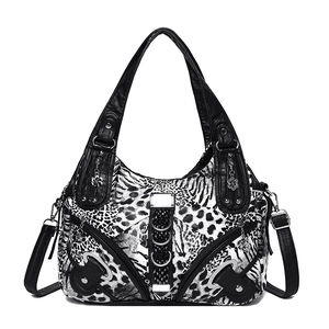 Black and white leopard print shoulder bag with zebra patterns and rivet details