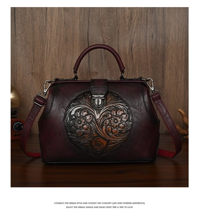 Detail of vintage embossed floral leather doctor bag in dark red with metallic clasp