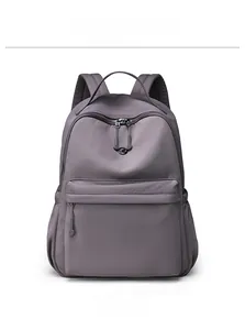 Detailed front view of mauve waterproof nylon backpack with smooth zipper and logo detail