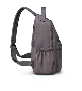 Side view of grey water-resistant nylon backpack with reinforced straps and side pocket