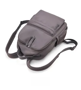 Detailed top view of dark grey water-resistant nylon backpack with multi-layer zipper pockets