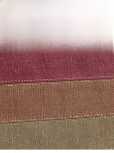 Close-up of durable canvas fabric with reinforced stitching in three colors