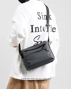 Detail view of a waterproof messenger bag with multiple zipper pockets and adjustable strap