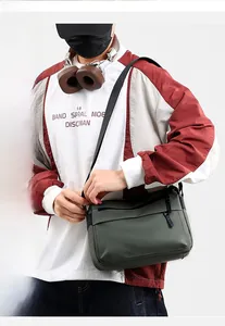 Waterproof olive green crossbody messenger bag with adjustable strap on urban model