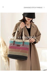 Detail of color-block canvas tote bag with striped pattern and leather reinforced straps