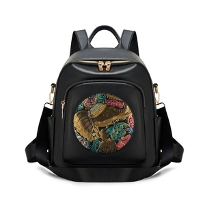 Black pebbled leather backpack with colorful elephant relief and golden zippers