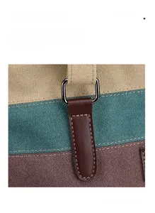 Detail of color-block canvas tote with leather straps and metallic D-ring hardware