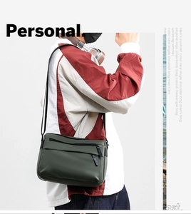 Waterproof messenger bag for men in dark green, shown in a stylish crossbody wear detail