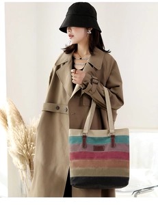Detail showing colorful striped canvas tote bag paired with a stylish khaki trench coat