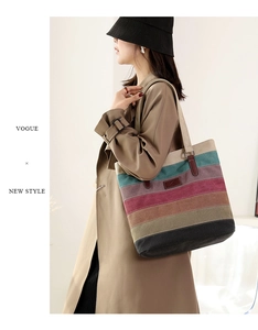 Detail of colorful striped canvas tote bag showing side view on model with shoulder strap