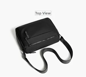 Top view of waterproof black messenger bag featuring multiple zipper compartments and nylon strap