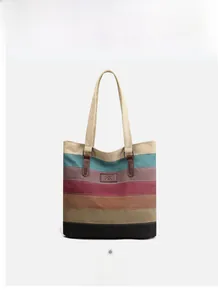 Detail shot of multi-colored striped canvas tote bag with long shoulder straps