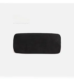 Close-up of minimalist black canvas tote bag showing durable texture and fine stitching