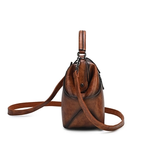 Retro brown embossed leather handbag with top handle and crossbody strap for women