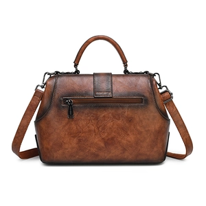 Vintage dark brown embossed leather doctor handbag with top handle and crossbody strap